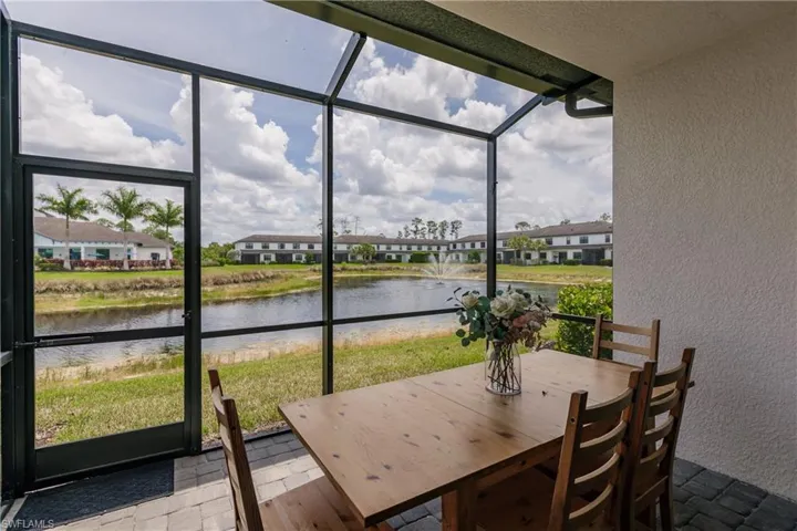 Sunroom featuring a water view and plenty of natural light