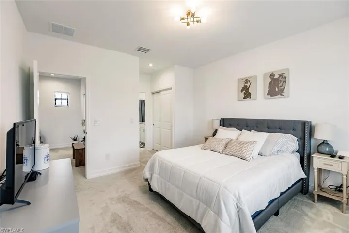 Carpeted bedroom with a closet