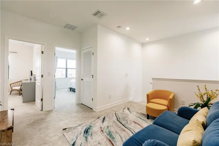 Living area with light colored carpet