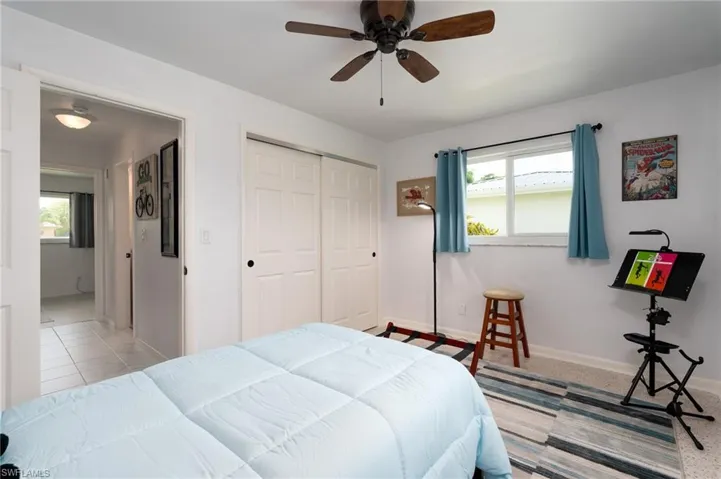 Bedroom featuring a closet, ceiling fan, and light colored carpet