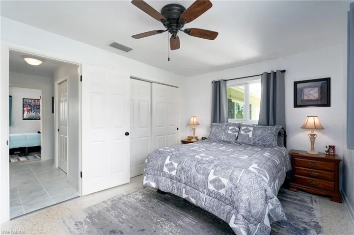 Bedroom with ceiling fan and a closet