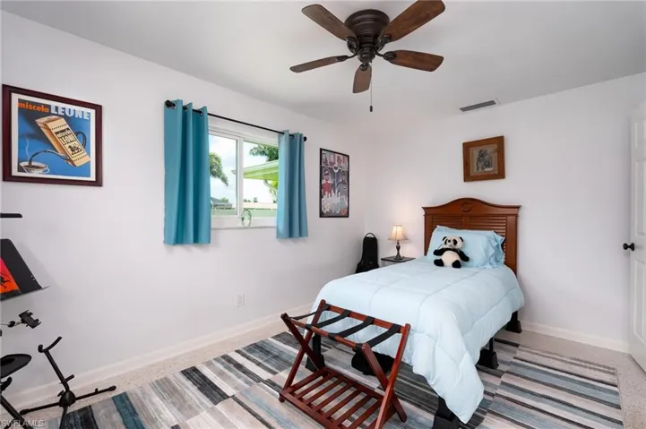 Carpeted bedroom with ceiling fan