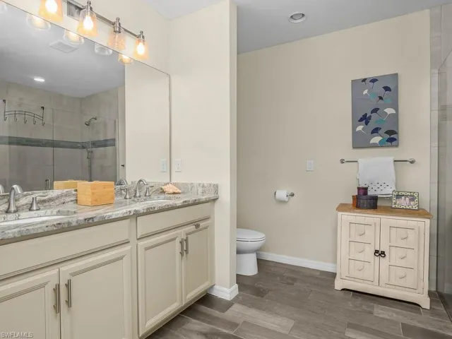 Large oversized primary bathroom with dual sinks,