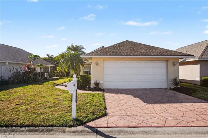 Single story home with stucco siding, a front yard, driveway, a garage, and roof with shingles
