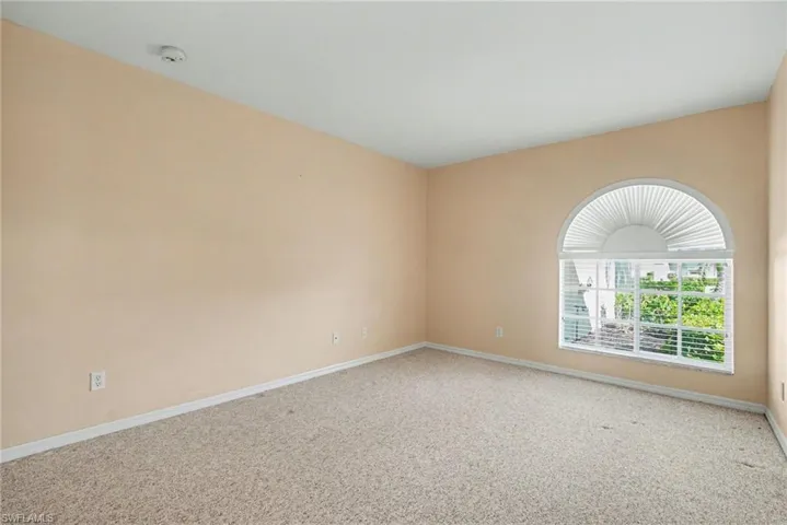 Carpeted empty room with baseboards