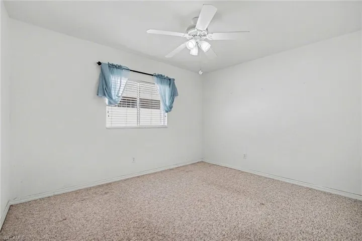 Spare room with baseboards and ceiling fan