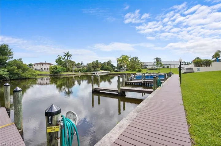 Dock featuring a water view and a lawn