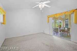 Spare room featuring ceiling fan and baseboards
