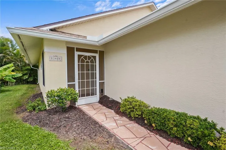 Doorway to property with stucco siding