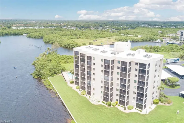 Aerial view of apartment complex / building and a nearby body of water