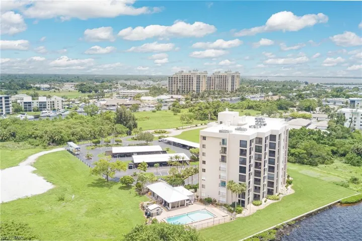 Drone / aerial view of a large body of water and apartment complex