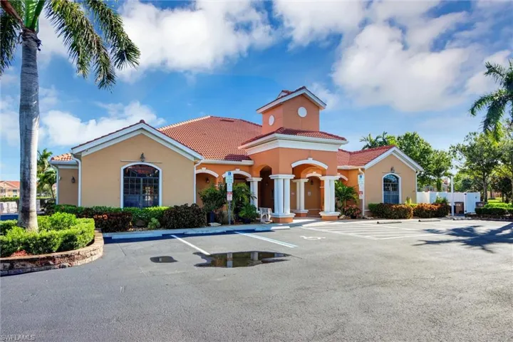 Mediterranean-inspired architecture with a tile roof, stucco exterior, and a central entry feature