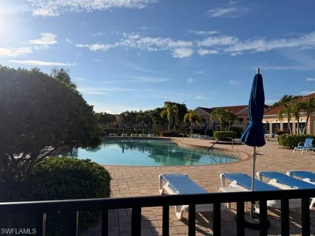 Outdoor swimming pool with integrated spa, surrounded by a paver deck