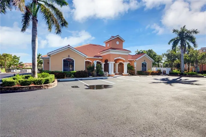 Mediterranean-style architecture with a terracotta tile roof, stucco exterior, and decorative columns