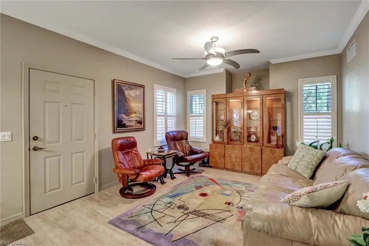 Crown molding accents a neutral-toned interior with tile flooring