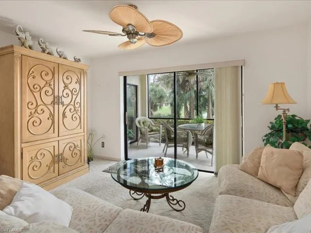 The LR has wall to wall carpet and a "Tommy Bahama" style ceiling fan.