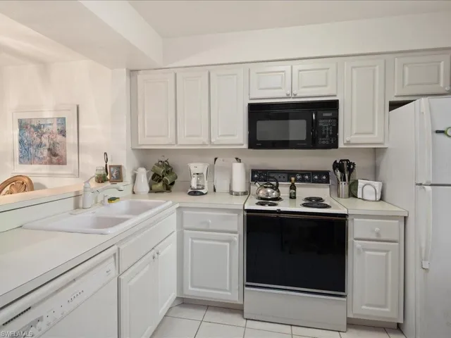 Updated eat-in kitchen has tile flooring, Whirlpool appliances and Hotpointe built-in microwave.
