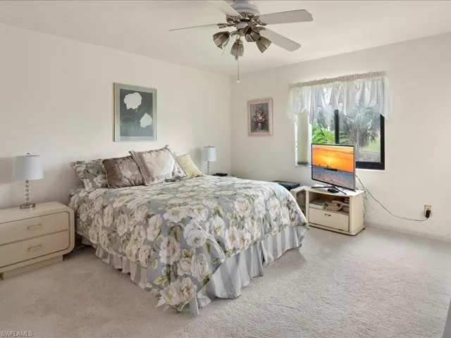 Primary BR has wall to wall carpet, walk-in closet, ceiling fan with lights, glass sliders to lanai and en-suite bath.