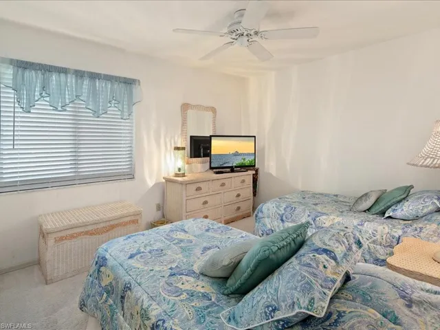The guest BR has wall to wall carpet, ceiling fan and double closet.