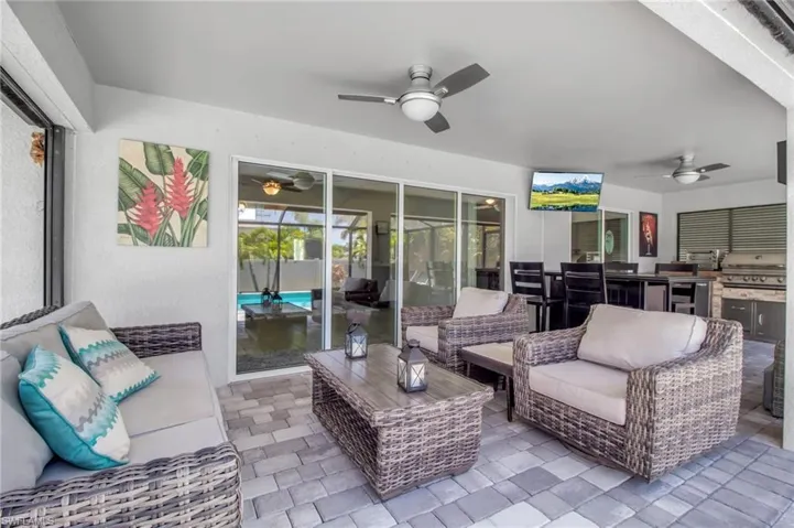 View of terrace with area for grilling, an outdoor living space, ceiling fan, and grilling area
