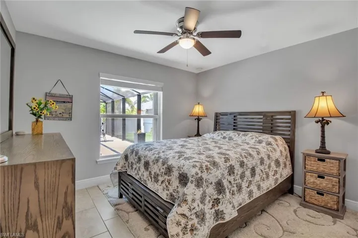 Bedroom featuring light tile flooring and ceiling fan