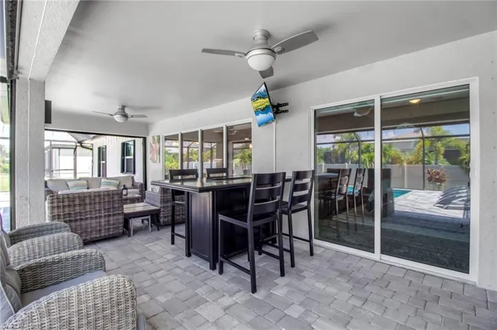 Sunroom featuring a wealth of natural light and ceiling fan