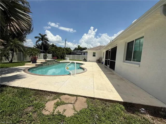 View of pool featuring a fenced backyard and a patio area