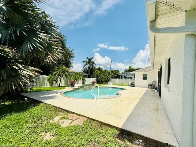 View of swimming pool with a fenced backyard and a patio