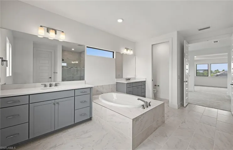 Dual sinks, walk-in shower, stand alone tub