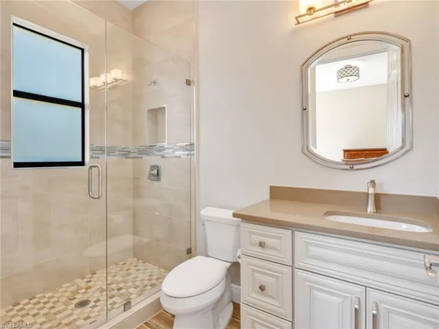 Full bath with vanity and a tiled luxury shower