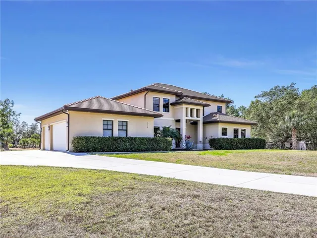 Front elevation showing side-load 3-car garage.