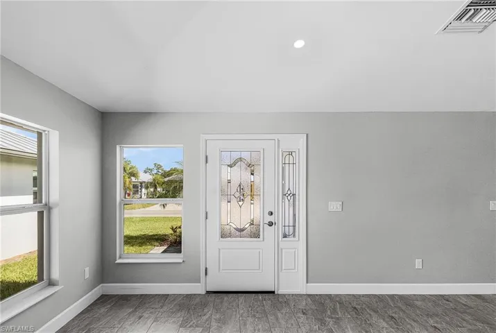 Entrance foyer featuring baseboards and recessed lighting