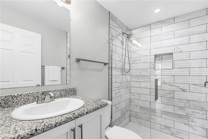 Full bath with vanity and a stall shower