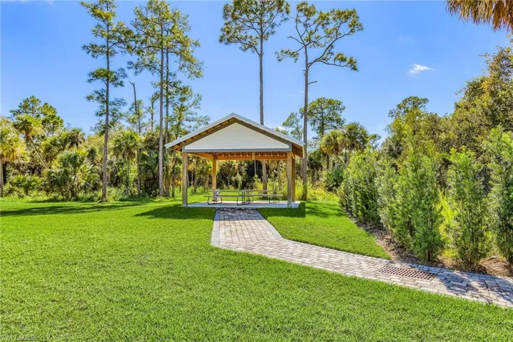 View of home's community featuring a yard and a patio area