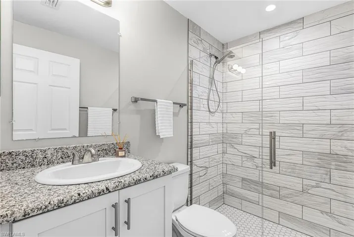 Full bathroom featuring vanity and a stall shower