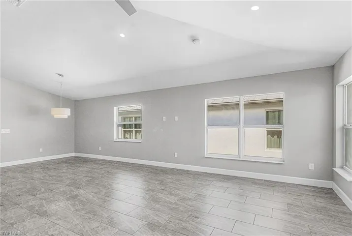 Spare room featuring baseboards and recessed lighting