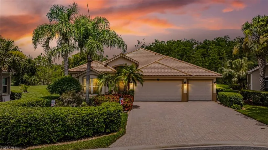 Mediterranean / spanish-style house featuring decorative driveway, a tile roof, stucco siding, and a garage
