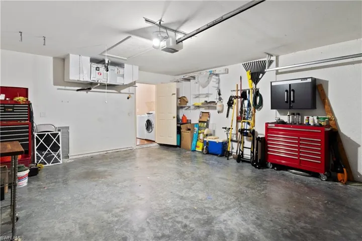 Garage featuring a garage door opener and washer and clothes dryer
