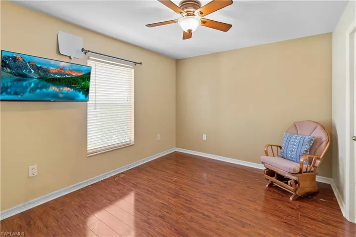 Unfurnished room with wood-type flooring and ceiling fan