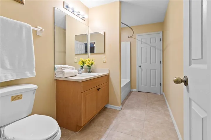 Full bathroom featuring vanity, toilet, bathtub / shower combination, and tile patterned floors