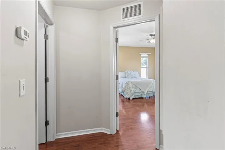 Corridor featuring dark wood-type flooring