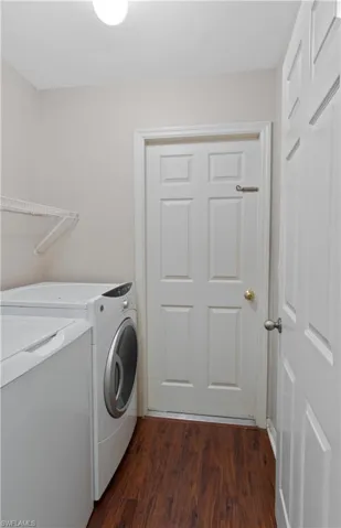 Laundry room featuring dark hardwood / wood-style flooring and separate washer and dryer