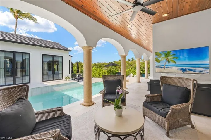 View of patio featuring an outdoor pool, ceiling fan, and an outdoor hangout area