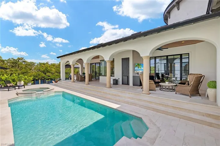 View of pool with a patio, an outdoor living space, and a pool with connected hot tub