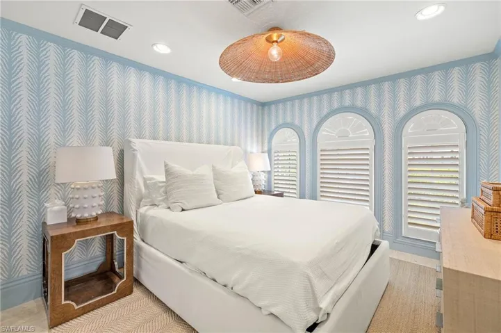 Bedroom featuring recessed lighting, wallpapered walls, ornamental molding, baseboards, and visible vents