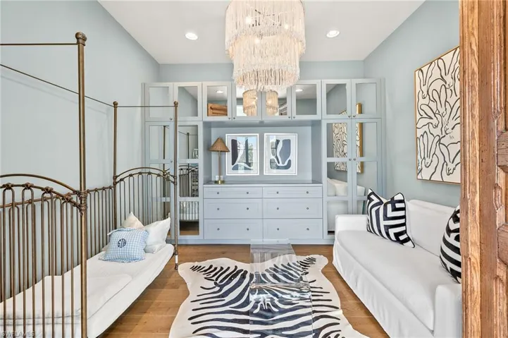 Bedroom featuring wood finished floors, a chandelier, and recessed lighting