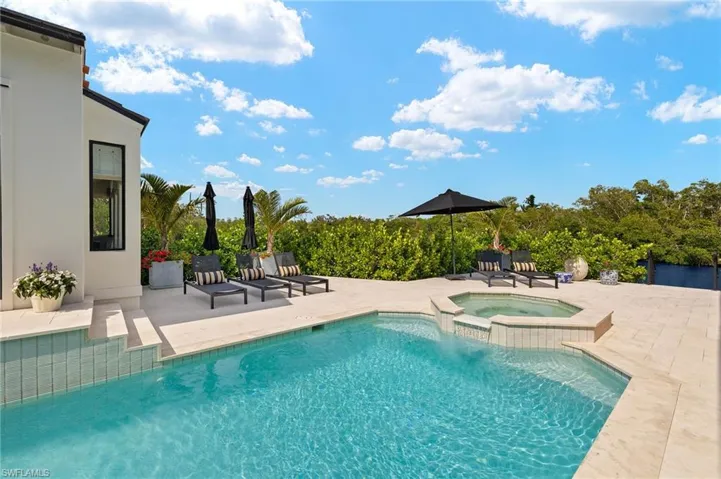 View of pool featuring a patio and a pool with connected hot tub
