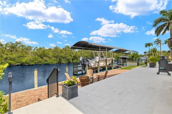 Dock area with boat lift and a water view