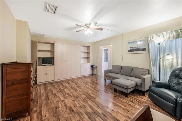 Living room with hardwood / wood-style floors and ceiling fan