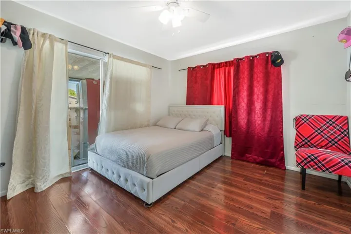Bedroom with dark hardwood / wood-style flooring and ceiling fan